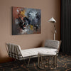 Colorful abstract painting on canvas hanging on the wall in a modern living room setting, featuring a white couch, metal side table, and floor lamp.