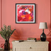 "Vibrant Abstract Artwork" - Framed abstract painting featuring bold, colorful brushstrokes in shades of red, orange, and purple, displayed on a pink wall above a wooden cabinet with decorative accents.