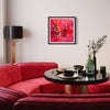 Vibrant abstract art print "Everglow" in a modern living room with a red velvet sofa, sleek black coffee table, and decorative vase with flowers.