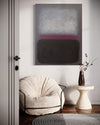 Minimalist abstract painting with vibrant colors on the wall, complemented by a cozy white chair and a decorative vase on a side table, creating a serene and modern interior design.