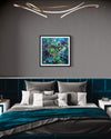 Abstract artwork framed on wall above modern bed with teal and gray bedding