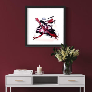 Vibrant abstract art print "Flying Tiger" on a burgundy wall, displayed on a white credenza with books, a candle, and a vase of flowers, showcasing a modern, earthy aesthetic.