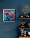 "Vibrant Abstract Art Print" - Captivating abstract artwork in vibrant colors displayed on the wall, complemented by natural decor elements such as dried coral and vases on a wooden shelf.
