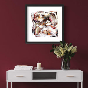 Abstract artwork with earthy colors in a framed print. Modern and vibrant artwork displayed on a red wall, complemented by a vase of white flowers and a wooden cabinet below. This piece, titled "Love the Sunshine" by artist Paresh Nrshinga, showcases an original abstract painting with a striking visual composition.