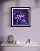 Vibrant abstract art print titled "Dreams of Revelation" displayed in a modern home setting with minimal decor, including a vase and a decorative bird figurine on a white shelf against a light purple wall.