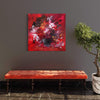 Vibrant abstract canvas art | Earthy, fiery colors in modern square painting | Richly textured contemporary artwork displayed on wall | Leather bench with metallic accents complements the artwork's bold palette | Potted plant adds natural greenery to the room's decor