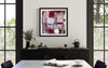 Framed abstract artwork with bold red and white colors, displayed on the wall in a modern dining room setting with a wooden sideboard and dining table.