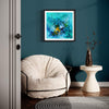 "Vibrant Abstract Aquatic Art" - Framed art print depicting a colorful, abstract underwater scene with splashes of vibrant blues and yellows, displayed on a teal wall in a modern interior setting with a plush chair and decorative vase.