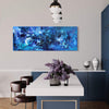 Large blue abstract painting titled "Across The Sea" on the wall of a modern interior with a dark blue sideboard, decorative vases, and a lighting fixture with multiple white spheres.