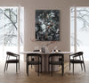 Chromatic Symphony 100x130cm - Abstract art painting with bold, contrasting colors and dynamic brush strokes, displayed prominently in a modern dining room setting.