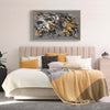 Earthy abstract art: Golden Whispers I - Large modern painting with vibrant brush strokes in browns, grays, and metallic tones, creating an abstract and textured artwork displayed above a soft, neutral-toned bed.