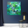 Vibrant Abstract Art | Birds of Paradise 100x100cm
Large abstract painting with a striking blend of green, blue, and yellow hues, creating a dynamic and captivating visual experience. Displayed on a gray wall, with a modern table lamp and side tables in the foreground.