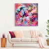 Large abstract square canvas depicting dynamic brushstrokes of vibrant pink, purple, and blue hues. Earthy tones of brown and orange add depth and warmth to the contemporary artwork. Suitable for modern homes and offices seeking a striking, colorful focal point.