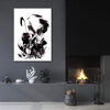 Monochrome abstract art piece with fluid, dynamic forms displayed on a dark gray wall above a rustic fireplace setting.