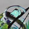 Large abstract painting with vibrant emerald, black, and blue brushstrokes on canvas