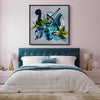 Large abstract painting of vibrant green, blue, and yellow swirls displayed in a modern bedroom with a tufted headboard and gold accents.