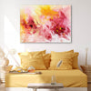 Vibrant abstract painting of peaches and lemons on a canvas displayed above a cozy yellow sofa with decorative cushions in a modern, minimalist living room setting.