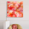 Large abstract painting of vibrant red, pink, and yellow colors on canvas