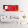 Large abstract red canvas art with bold brushstrokes and vibrant colors, displayed on a white wall above a gray sofa and surrounded by modern home decor elements.