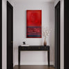 Large abstract red painting on wall, black console table with decorative vase, modern hallway interior