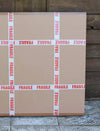 Fragile boxes surrounded by wooden planks in an image
