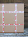 Fragile cardboard boxes stacked on a wooden surface