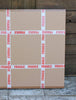 Fragile cardboard boxes stacked on a wooden surface