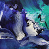 Vibrant abstract canvas art with swirling brushstrokes in shades of blue, purple, and green. Captivating artistic expression with depth and movement.