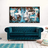 Vibrant abstract landscape painting "Summer Rain (gloss)" | 32x60" canvas art | Modern artwork with bold blue and brown tones displayed above a teal velvet chesterfield sofa on a light hardwood floor