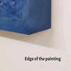Vibrant abstract painting with bold blue brushstrokes on large canvas
