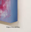 Vivid abstract landscape painting with vibrant pink and blue tones, displayed on a white surface.