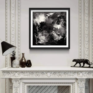 "Dramatic Abstraction" - Signed Edition Art Print
Framed black-and-white abstract artwork displayed above a decorative mantelpiece, surrounded by vintage decor items such as a lamp, vases, and a figurine. The artwork features a bold, moody, and expressive abstract composition, capturing a sense of movement and depth.