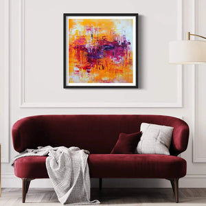 "Vibrant Abstract Art" - Colorful modern abstract artwork with warm hues displayed on a white wall above a burgundy sofa in a cozy living room setting.