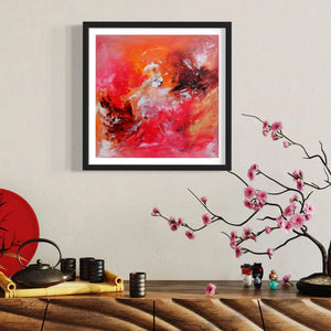 Vibrant abstract art print in red and white tones framed and displayed on a wall, surrounded by Japanese-style decor items like a bonsai tree and traditional teaware.