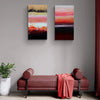 Vibrant abstract landscape diptych painting of caramel-colored dunes set against a dramatic sunset sky, displayed on the wall above a red upholstered bench in a modern interior.