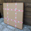 Large cardboard boxes with "Fragile" warning labels on a wooden background
